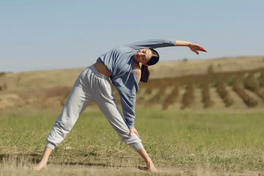 Person performing a gentle side stretch outdoors, demonstrating low-impact movement for physical comfort in Australia.
