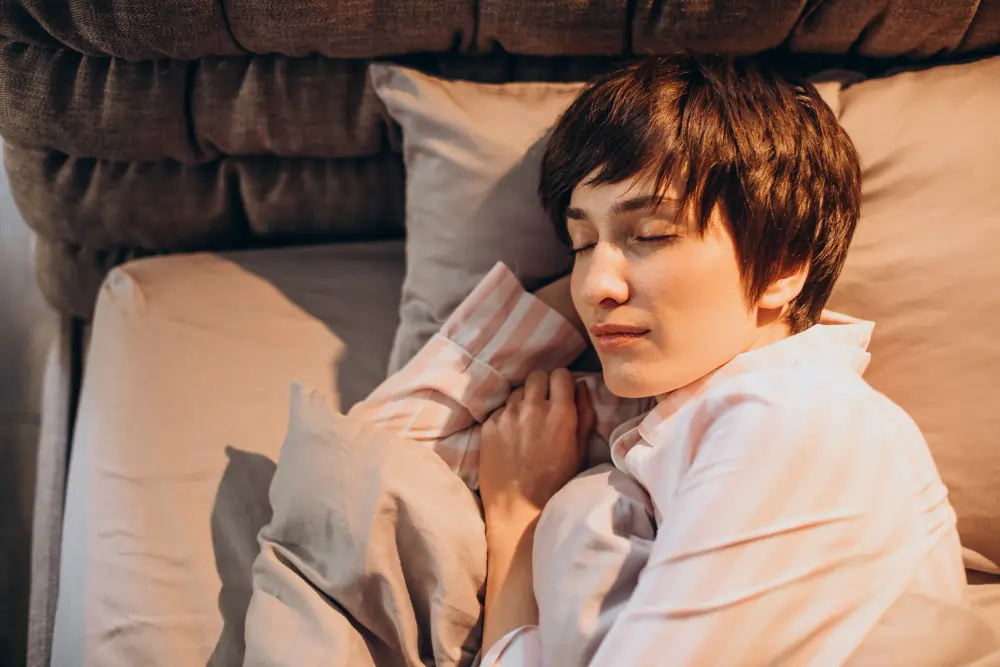 Understanding Sleep Cycles: What Your Body Does While You Rest - Female Spleeping on the bed.