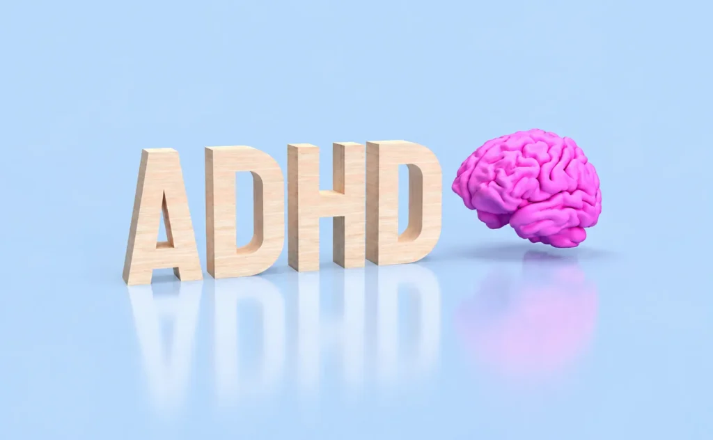 3D ADHD letters beside a colorful brain illustration representing ADHD awareness, neurological understanding, symbols, and the history of attention disorder recognition.
